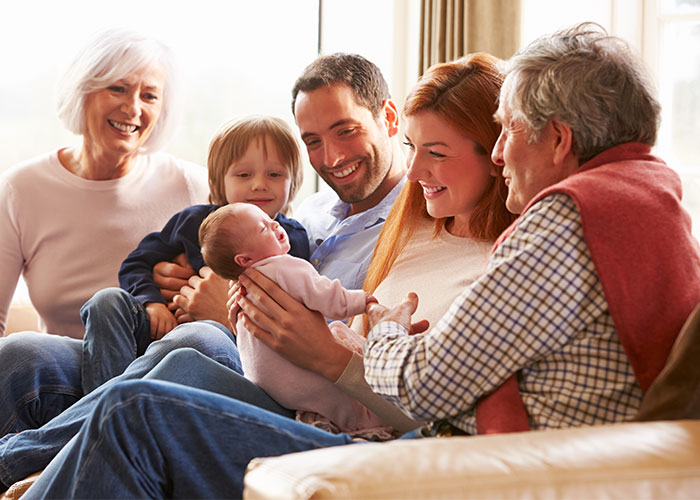 Happy family on the couch with baby