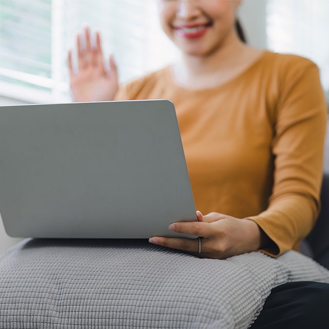 Woman waving on webcam